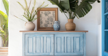 Rustic wooden console table styled with sunflowers, warm-toned books, and woven baskets, creating a welcoming late-summer entryway.