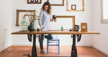 A cozy home office with handcrafted wooden furniture, warm lighting, a rustic wooden desk, and soft natural textures creating a calm, inviting workspace.