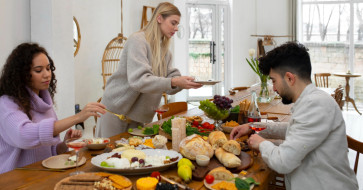 Rustic wooden dining table styled for a cozy Thanksgiving gathering.
