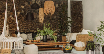 A cozy living room combining modern furniture with rustic accents—like a sleek sofa, vintage wood table, and layered textures—capturing warm, balanced style.