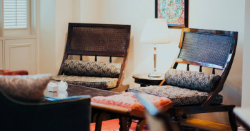 Cozy, modern living room setup featuring essential furniture pieces like a plush sofa, stylish dining table, and a personalized accent chair — perfect for 2025 homes.