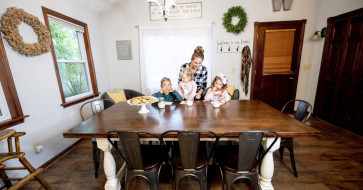 The Classic Farmhouse Table – Sturdy wooden farmhouse dining table with weathered finish, perfect for family gatherings.