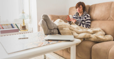 Cozy winter living room with upholstered sofa and warm wooden furniture